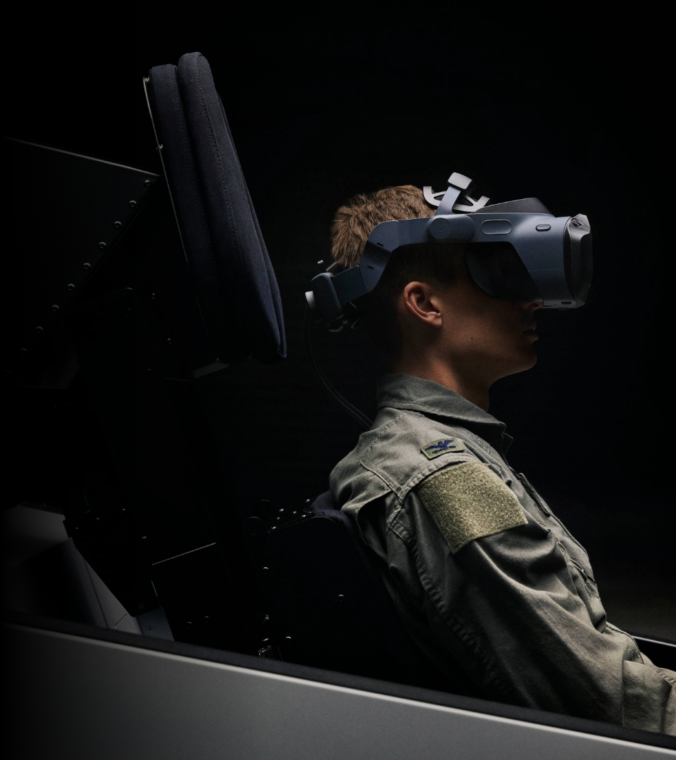 a pilot sitting in a cockpit wearing a Varjo XR-4 Series headset